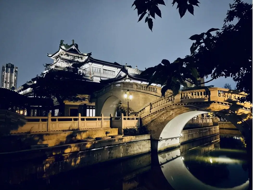 Stone arch bridge over a canal in Xiguan at dusk