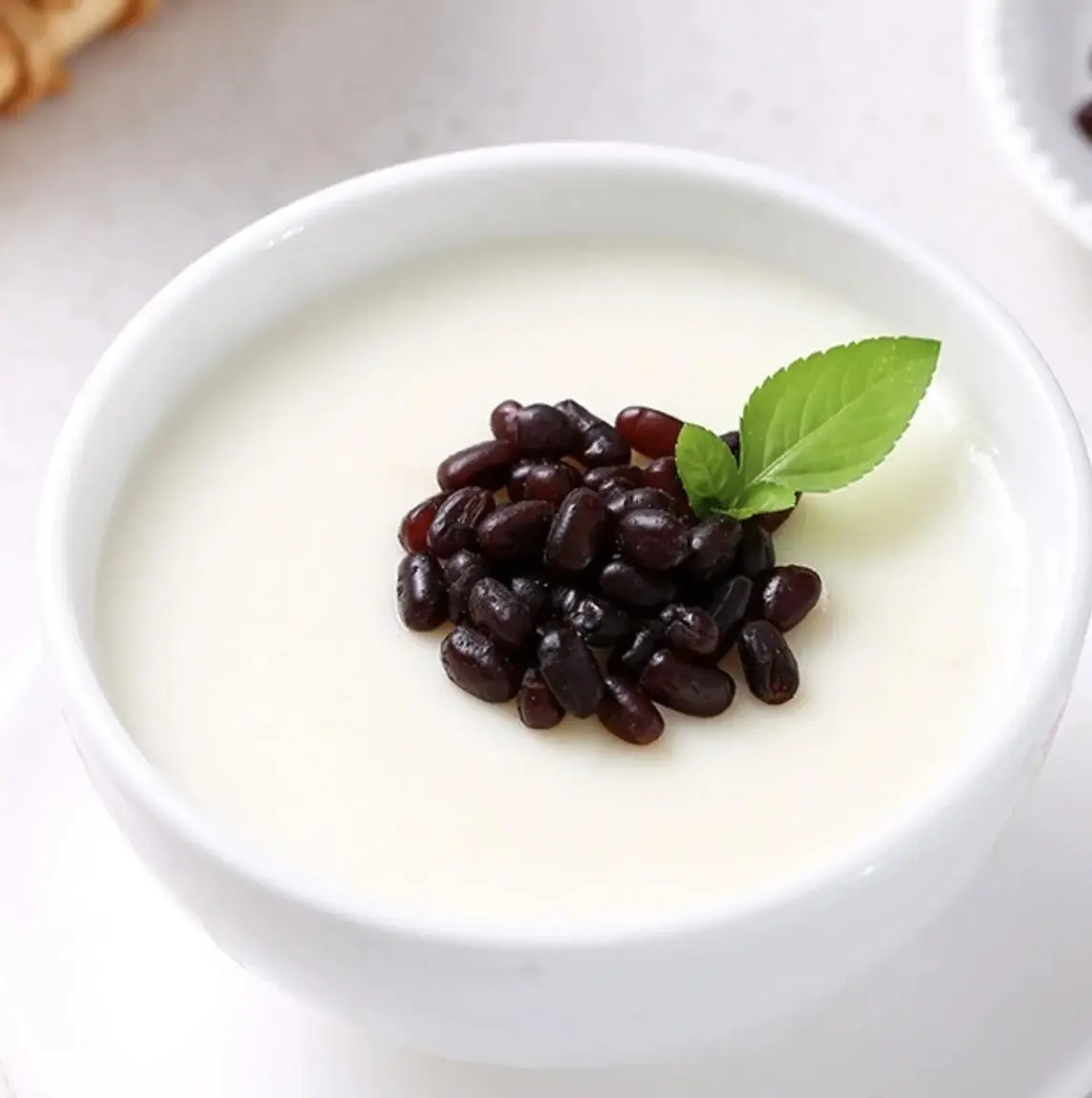 Double-skin milk pudding with red beans in a blue-and-white porcelain bowl