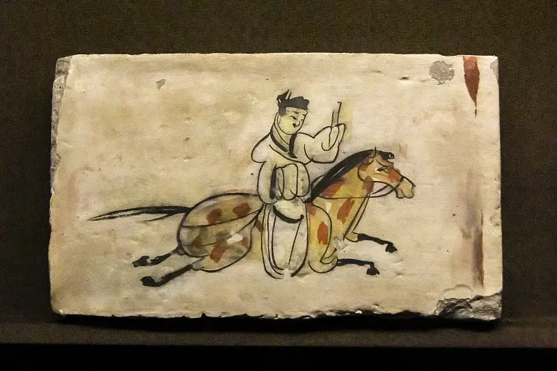 Wei-Jin postal messenger painted brick, mounted rider holding a tall wooden tablet on an ancient yellowed tomb tile