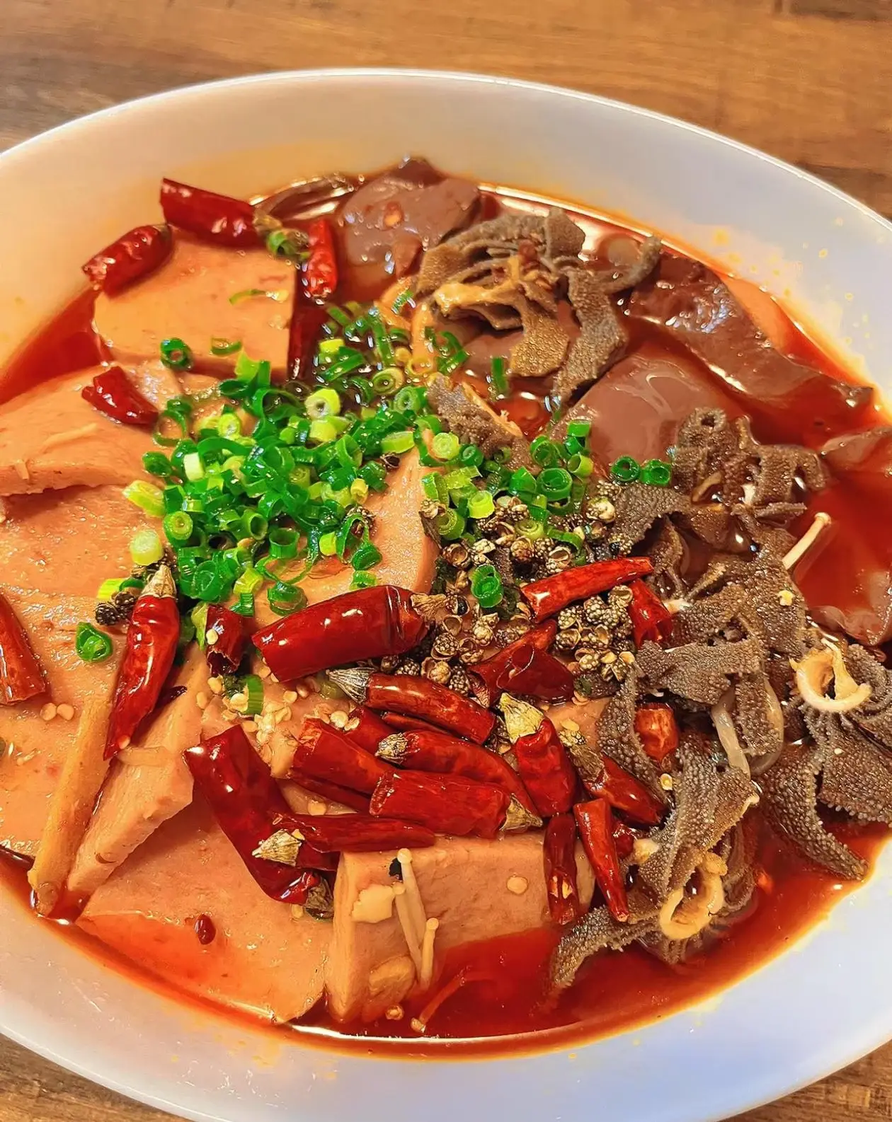 A plate of maoxuewang with duck blood and tripe in bright chilli oil