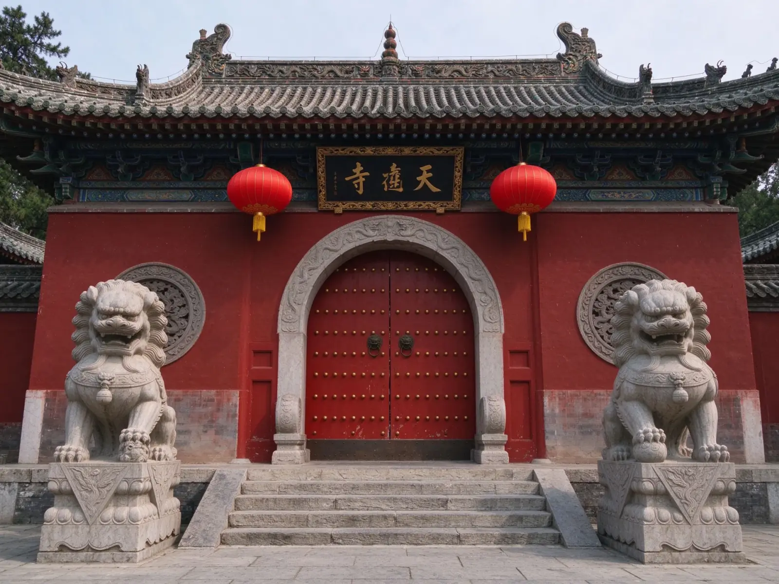 The entrance gate of a Taoist temple with red lanterns and stone lions