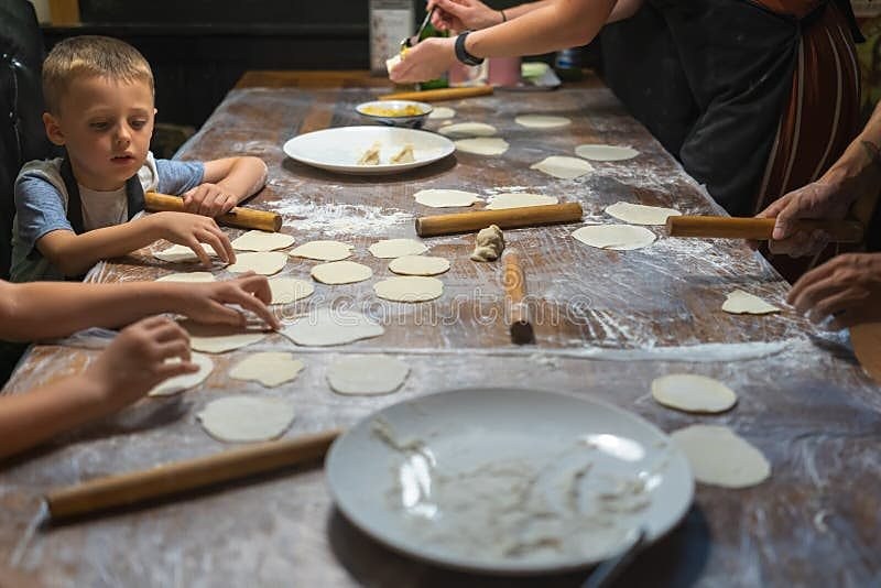 A child learning to make dumplings