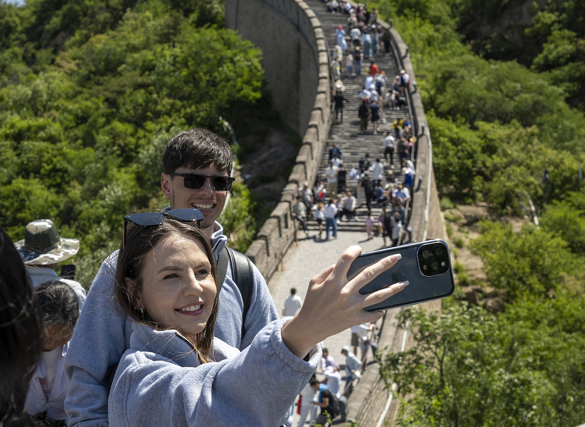 A young couple taking a selfie on the Great Wall of China