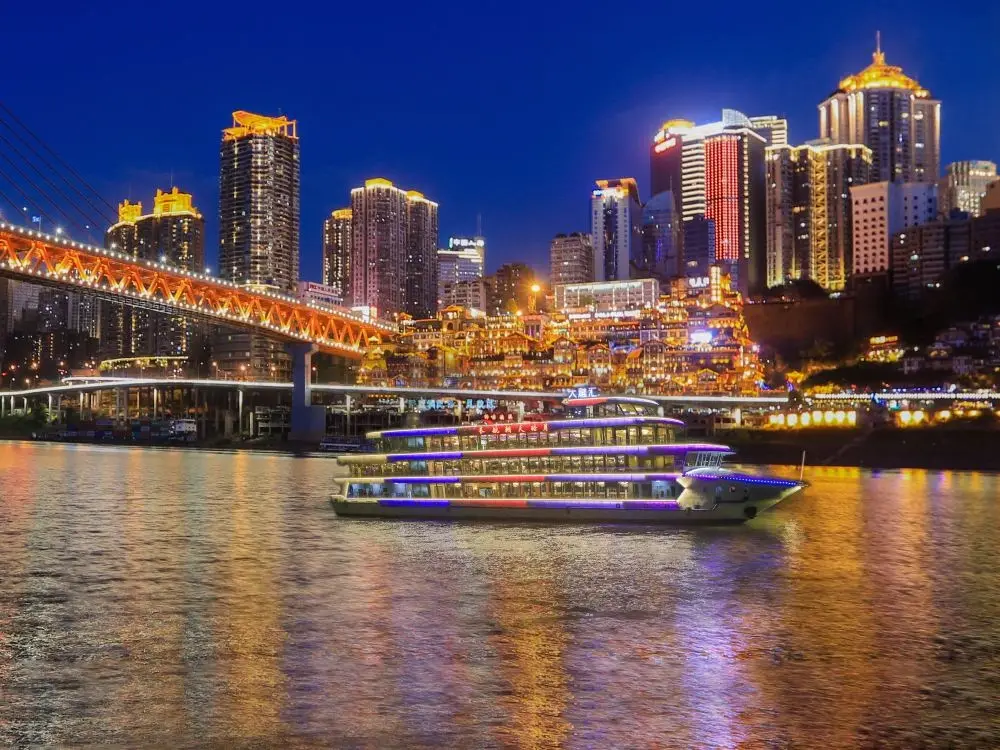 An illuminated Two Rivers sightseeing boat