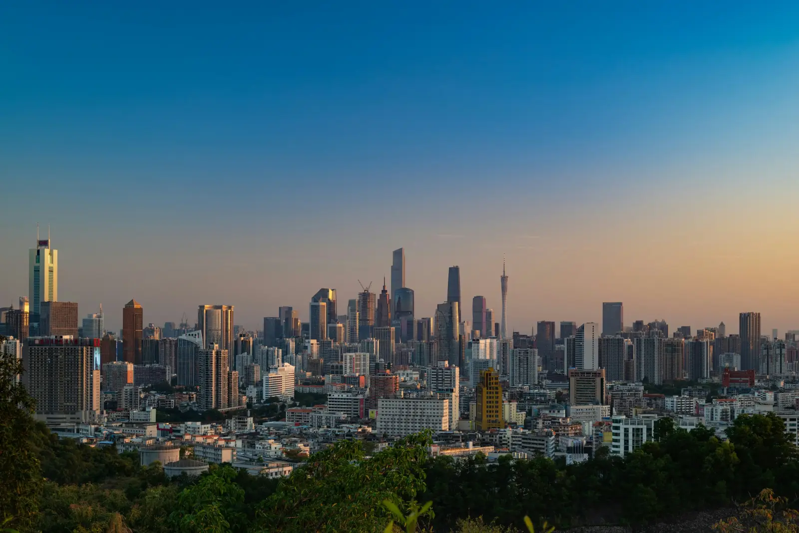 Guangzhou skyline beyond green hills