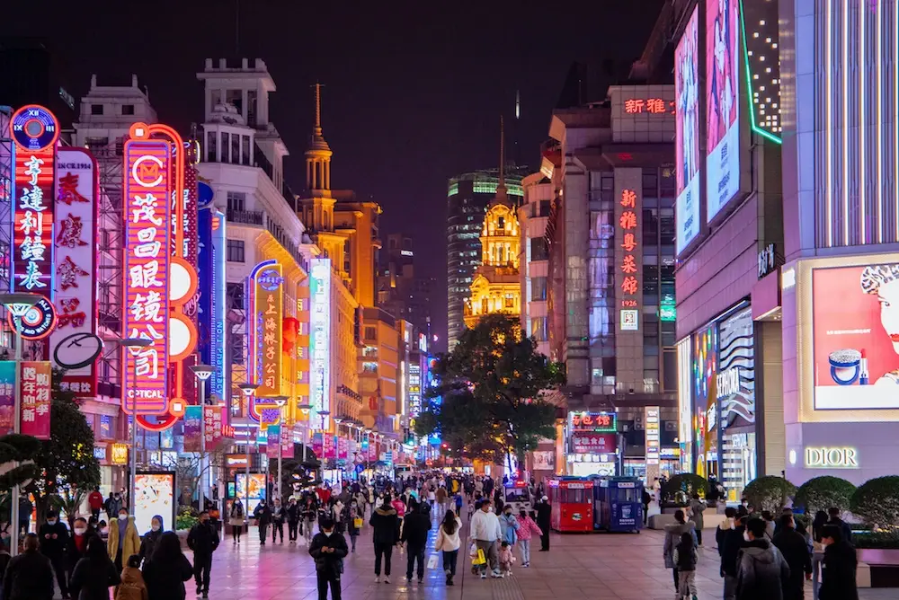 Neon signs and evening visitors on Nanjing Road pedestrian street