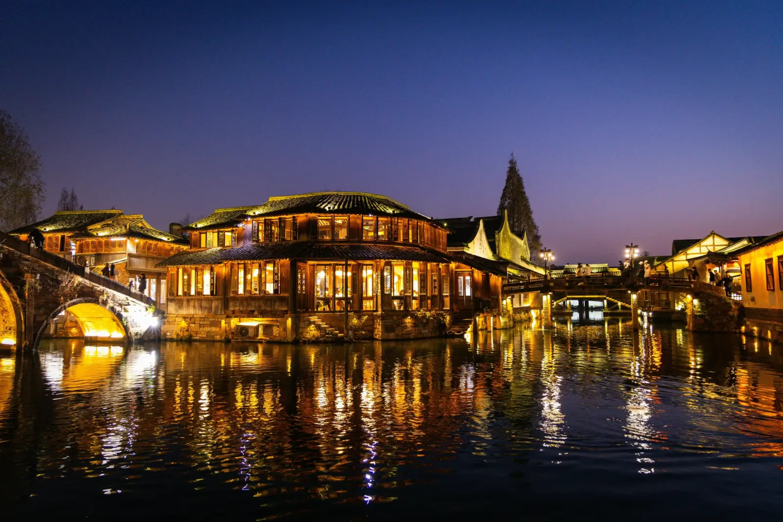Warm lights reflected in Wuzhen's canals