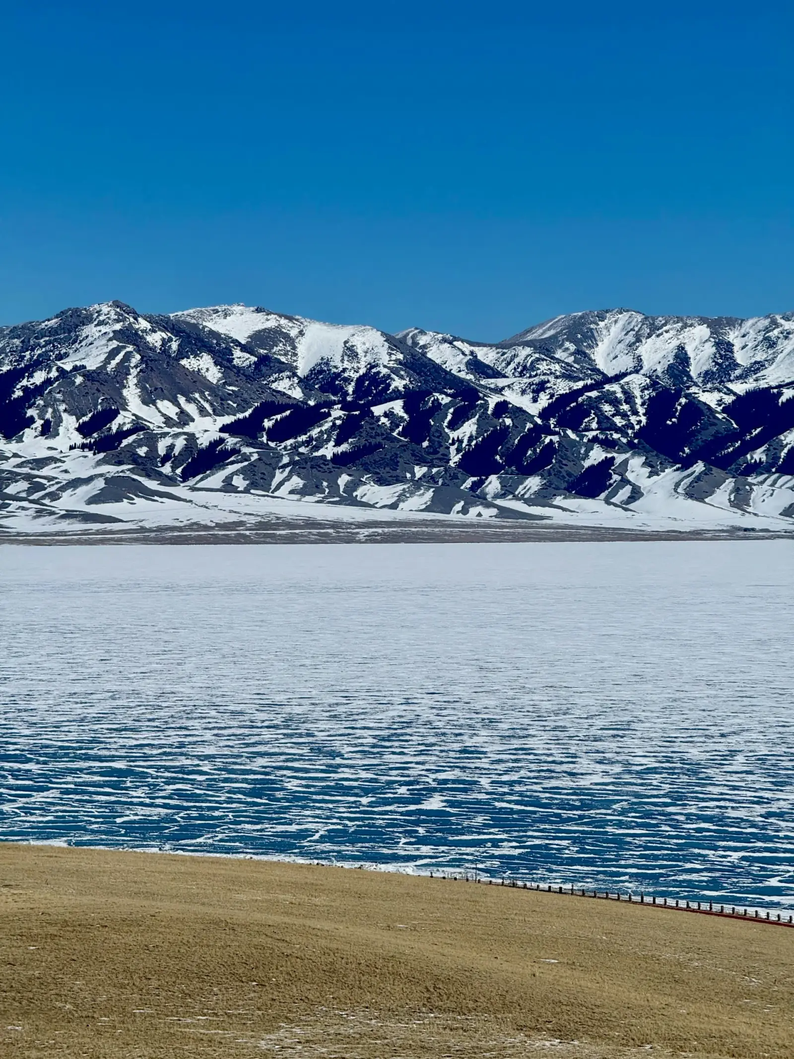 Sayram Lake blue ice and snow-covered mountains