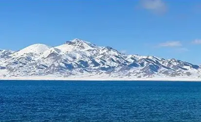 Snow-covered mountains beside Sayram Lake