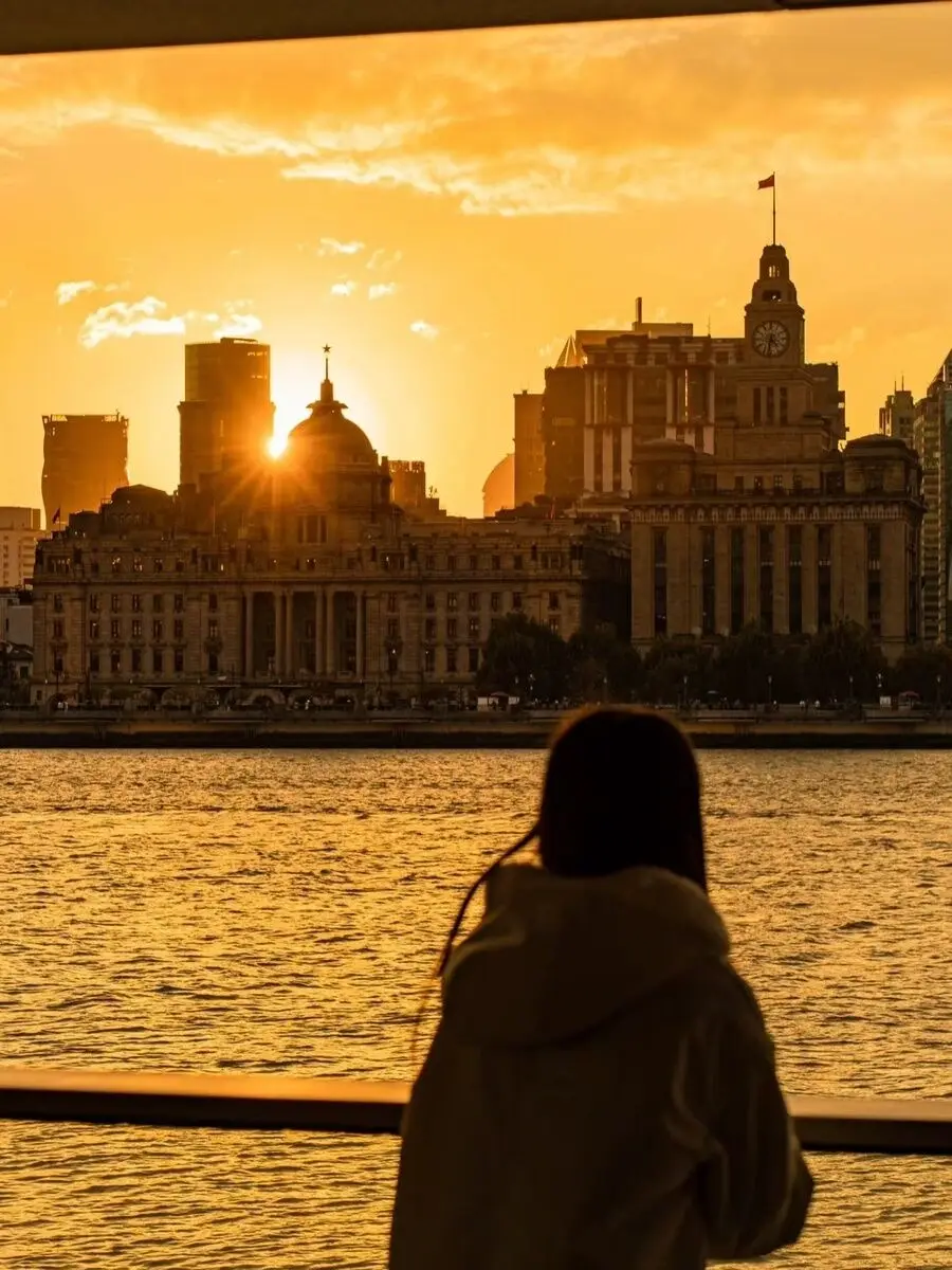 Golden sunset over the historic Bund seen from the Huangpu riverside