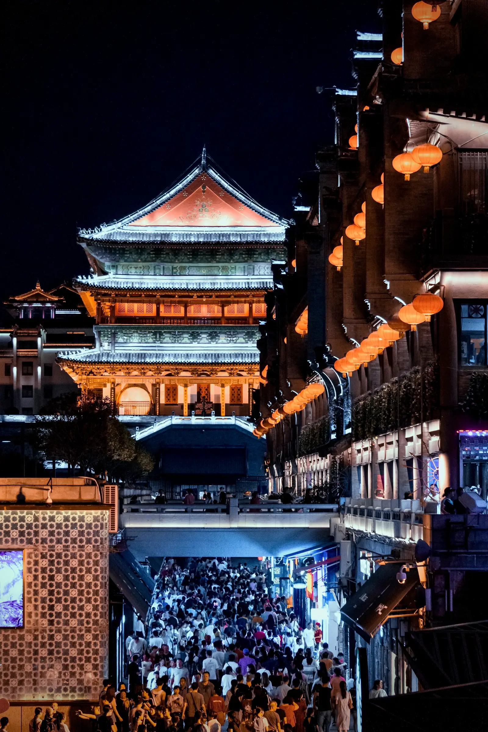 Xi’an Drum Tower above a bustling illuminated street
