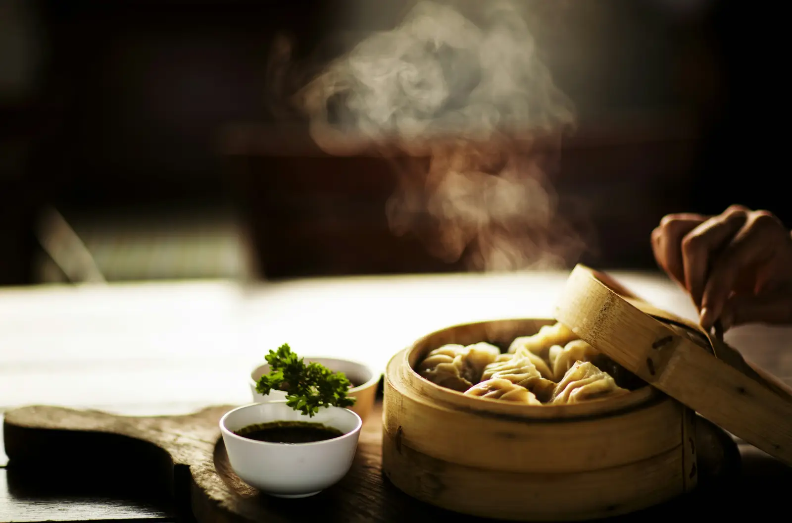 Dumplings in a bamboo steamer with rising steam
