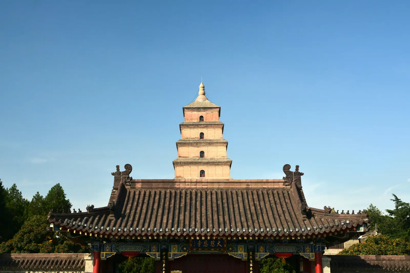 Giant Wild Goose Pagoda above the traditional roofs of Daci’en Temple